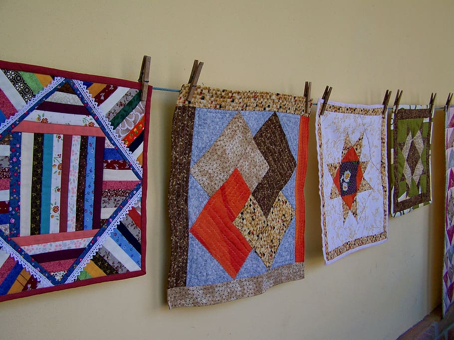 quilting, manual work, exhibition, hanging, indoors, wall - building feature, multi colored, pattern, clothing, architecture