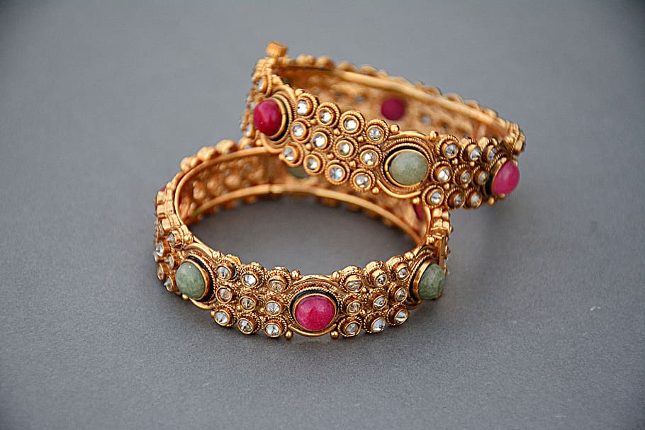 two gold-colored bracelets, jewellery, gold, gold jewelry, luxury, jewelry, woman, fashion, wealth, gemstone