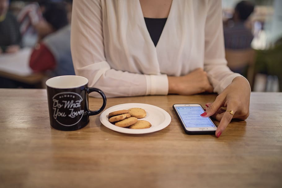 woman, cafe, phone, browsing, snack, cookies, coffee, cup, breakfast, reading