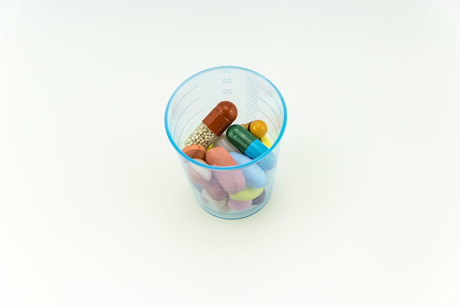 assorted-color capsules, tables, blue, plastic cup, white, surfacxe, medical, pharmacy, capsule, pill