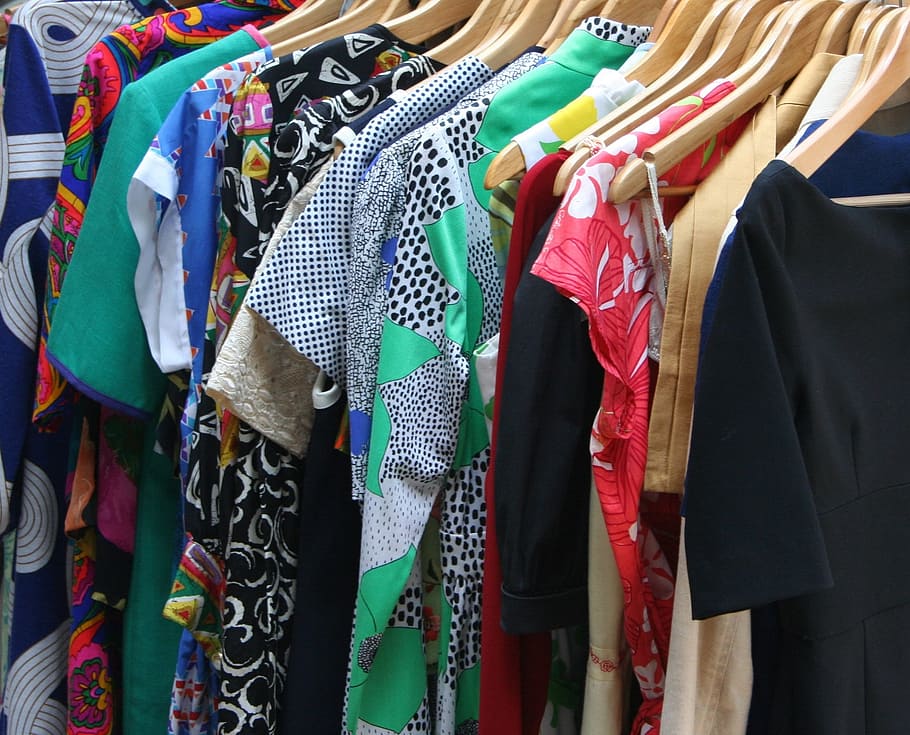 assorted-colored tops, dresses, apparel, clothing, clothes, clothes hangers, wooden hangers, retail shop, closet, dress