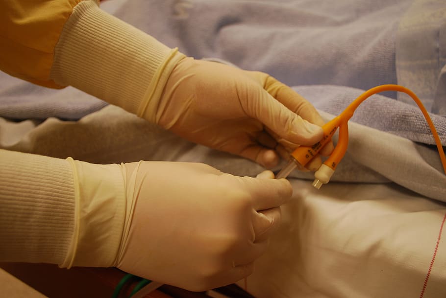 person, holding, orange, cable, hands, gloves, catheter, health care, care, yellow
