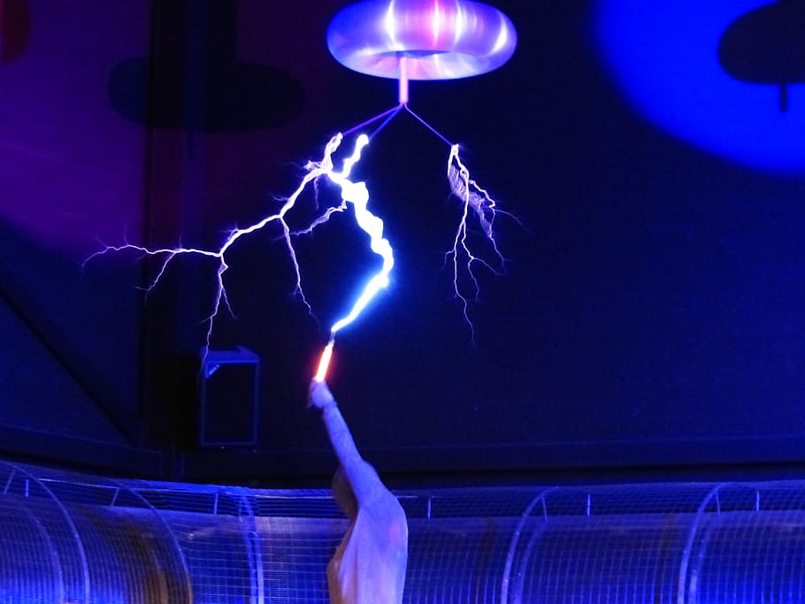 person, holding, orange, tool, lightning effect, ceiling, flash, tesla coil, experiment, high voltage