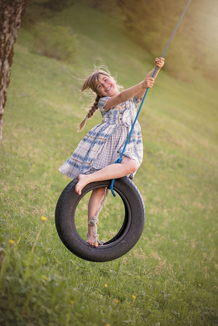 woman, wearing, blue, gray, dress, rubber tire swing, person, human, child, girl