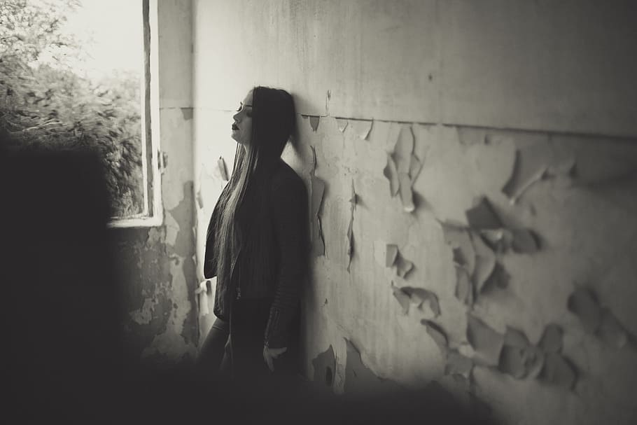greyscale photo, woman, leaning, wall, daytime, girl, white, black, gothic, portrait