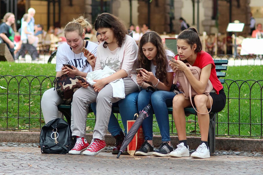 four, woman, sitting, bench, girls, cell phones, distracted, cell phone, cell, phone