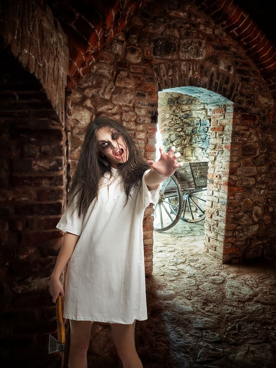 psychopath woman, holding, axe, inside, brick house, daytime, halloween, fear, weird, creepy