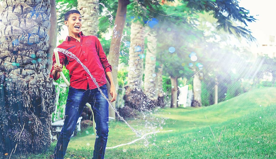 man, wearing, red, button-up, long-sleeved, shirt, holding, garden hose, real, standing