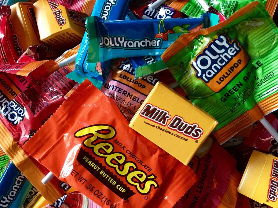 assorted candy packs, Candy, Sweets, Halloween, Treats, reece's, milk duds, jolly rancher, colorful, text