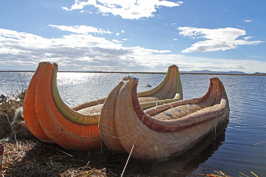 two, brown, boats, docked, land, peru, lake-titicaca, canoes, water, sky
