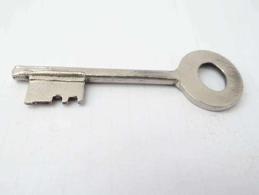 key, security, metal, steel, silver, white background, studio shot, close-up, indoors, single object