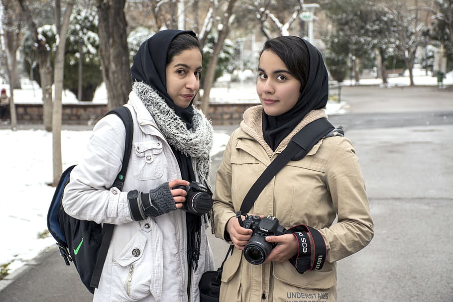 two, woman, standing, holding, cameras, snow time, Mashhad, Girls, Mellat Park, Winter