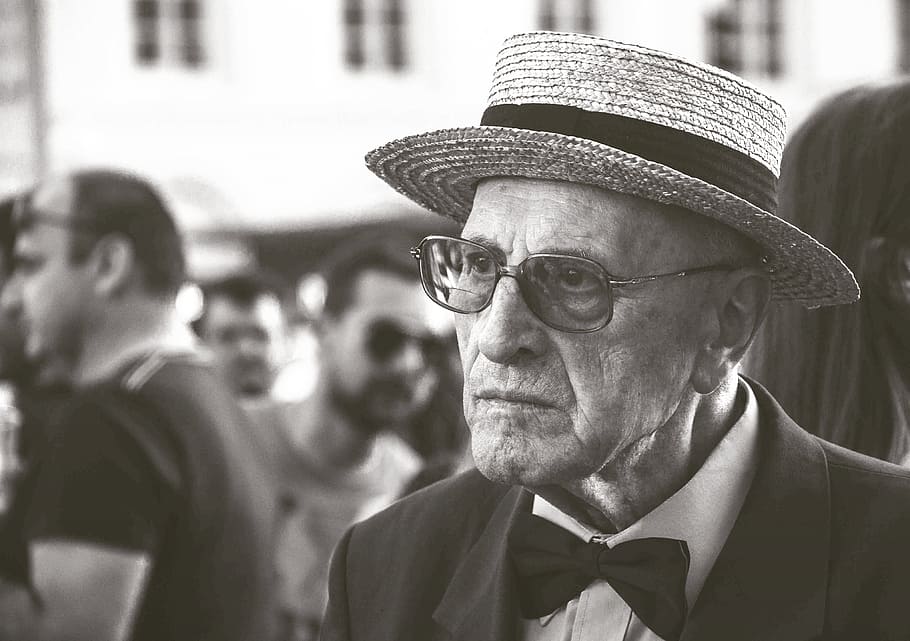 close-up photo, man, wearing, tuxedo, straw hat, aged, elderly, macro, old, person