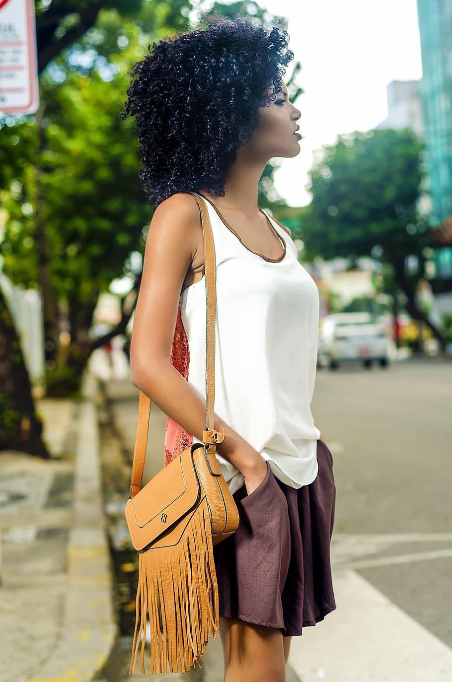 woman, white, tank, top, brown, leather shoulder bag, standing, street, daytime, fashion