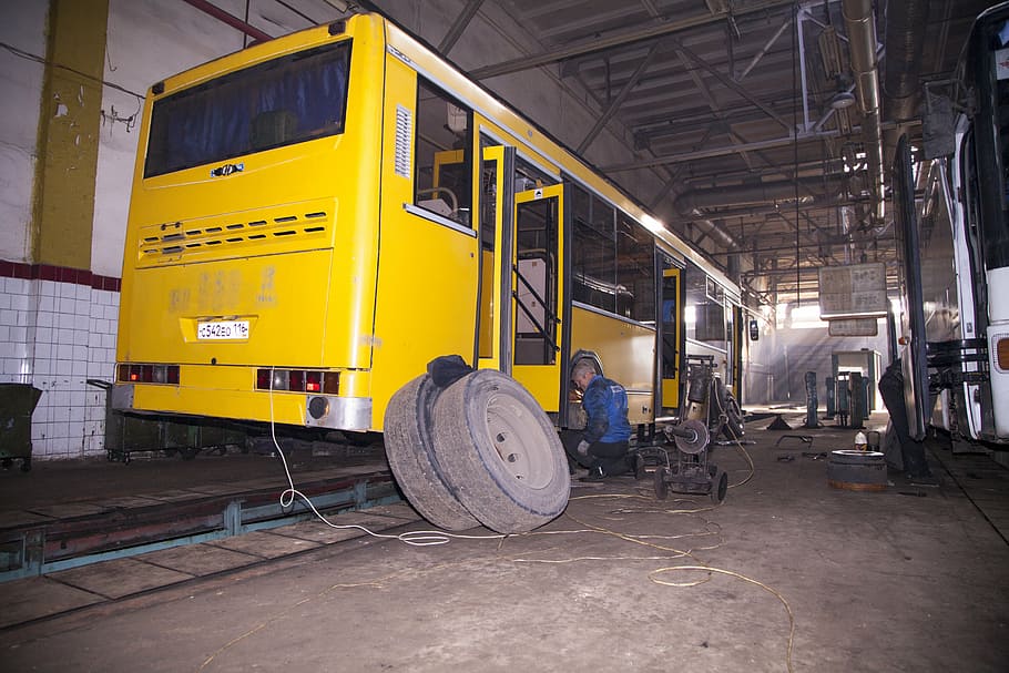 bus, wheel, repair, shop, men, industry, occupation, real people, architecture, built structure