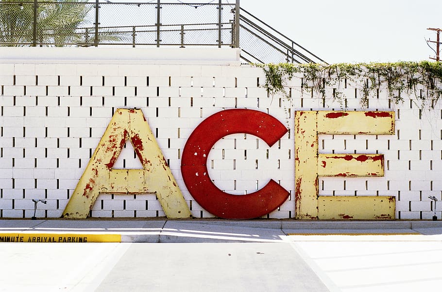 ace signage, wall, ace, freestanding, letters, white, concrete, bricks, vines, red