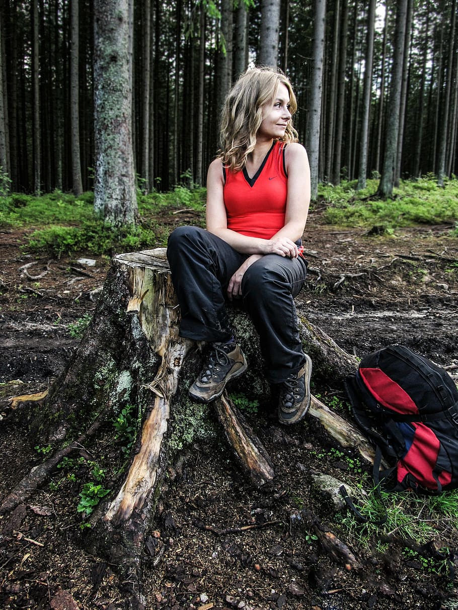 woman, wearing, red, v-neck, top, sitting, brown, tree stomp, trekking, forest