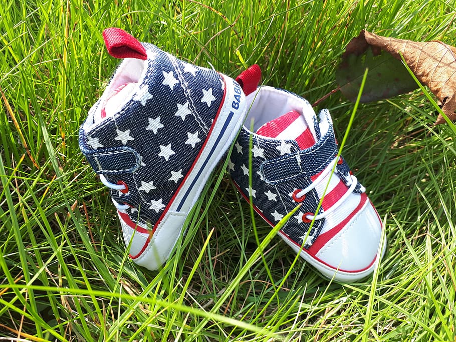 baby shoes, shoes, baby, children's shoes, grass, flag, patriotism, plant, field, high angle view
