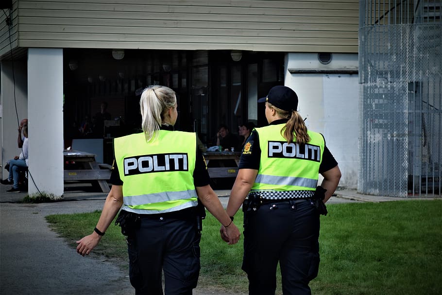 the police, authorities, arrest, norway, architecture, standing, real people, three quarter length, women, text