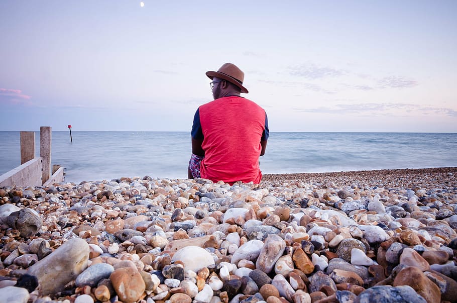 man, sitting, beach pebbles, men, s, wearing, red, black, long, sleeve