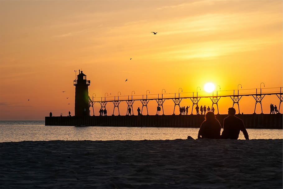 silhouette photo, man, woman, sitting, shoreline, golden, hour, Sunset, Pier, Lighthouse