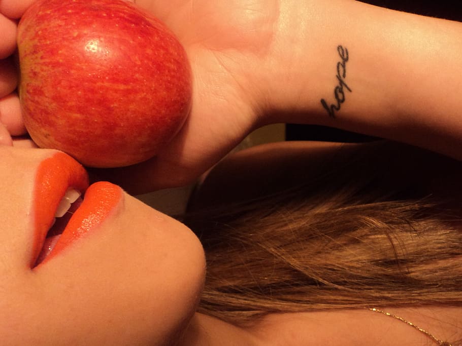 person, holding, red, apple fruit, apple, lipstick, lips, human body part, human hand, hand