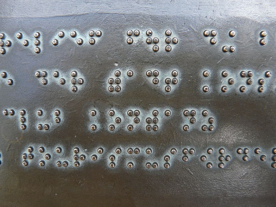 person, showing, black, steel board, Braille, Font, Keys, Metal, Plate, Bronze