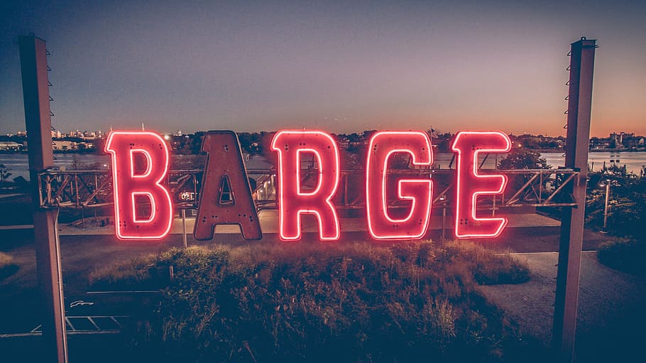 barge billboard, red, barge, neon, lighted, signage, font, dark, light, grass
