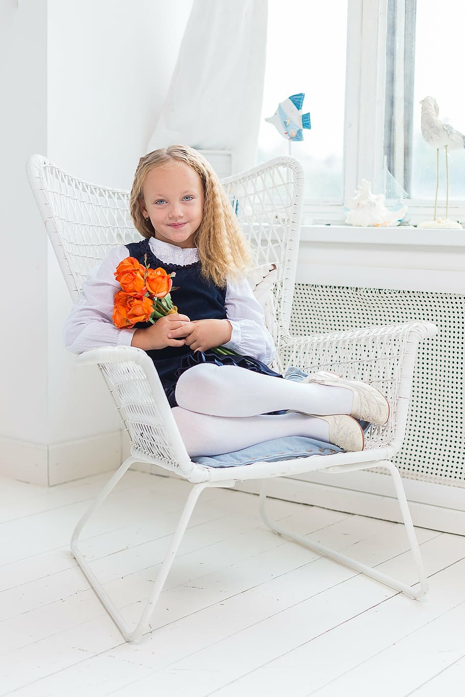 girl, holds, orange, rose, flowers, sitting, white, metal armchair, young, blue eyes