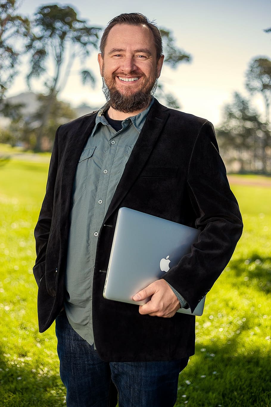 man, black, coat, holding, silver macbook, portrait, outdoor, smiling, developer, development