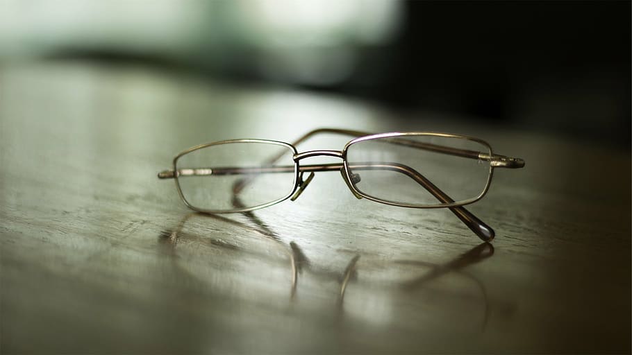 silver-color, framed, eyeglasses, brown, wooden, table, gray, glass, reading, top