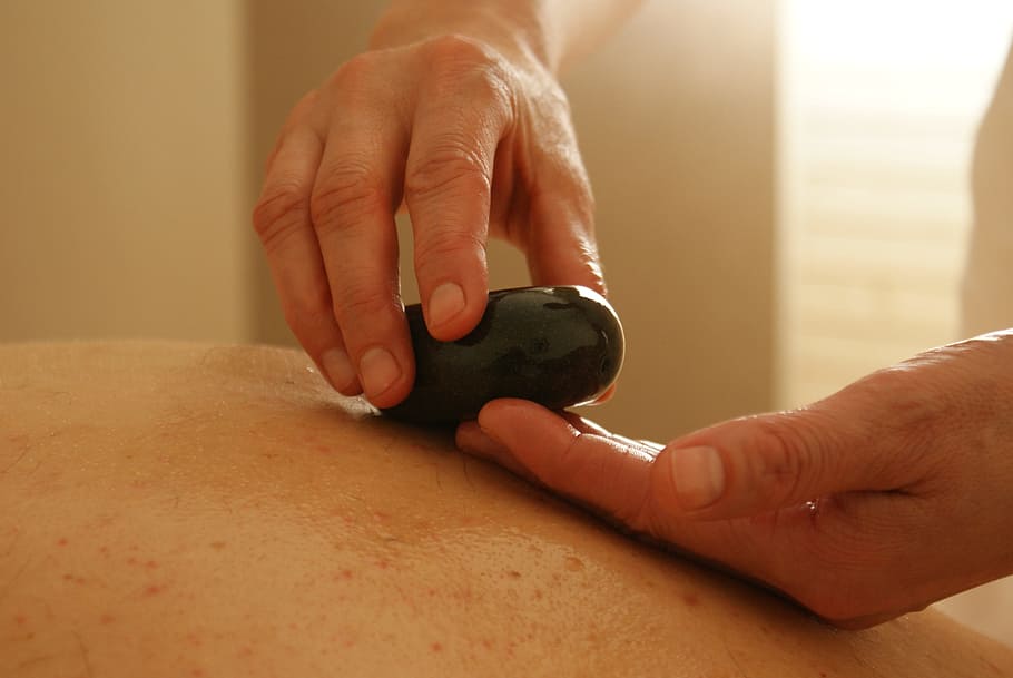 selective, focus, photographed, person, holding, black, polished, stone, massage, relaxation massage