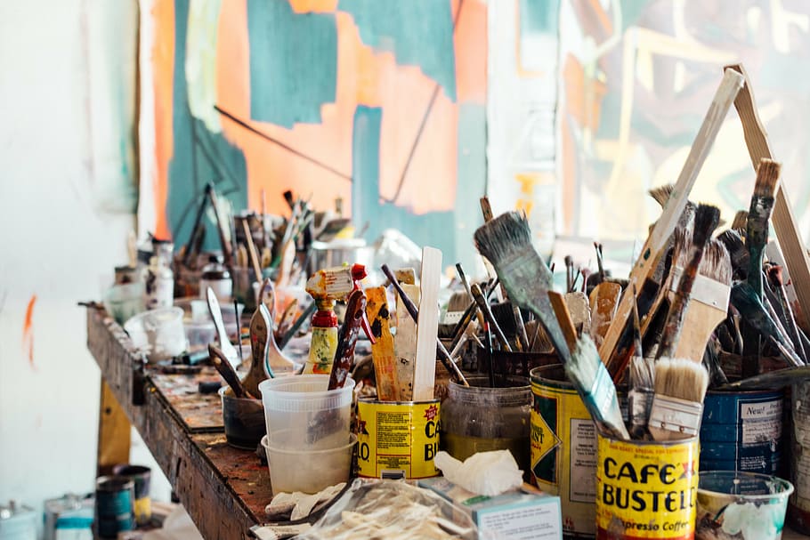 assorted, paint cans, paintbrushes, brown, wooden, table, paintbrush, tin, cans, paint