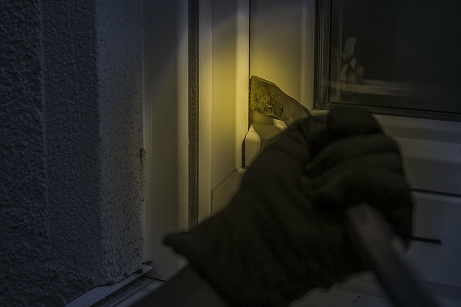 person, holding, black, steel frame, burglar, at night, window, crowbar, flashlight, glove