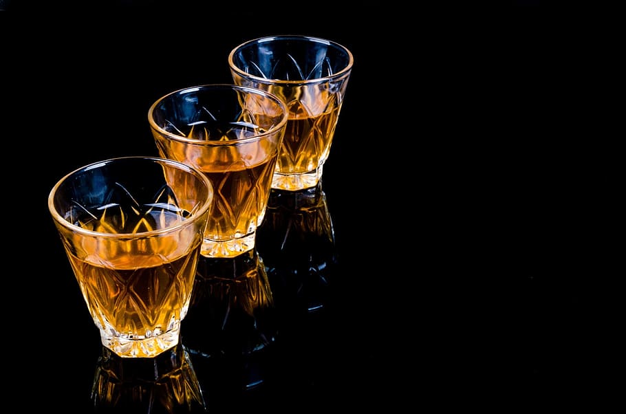 three, clear, shot glasses, black, surface, bar, liquor, barman, pouring, close-up