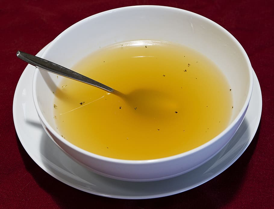 round, white, bowl, filled, yellow, liquid, clear broth, soup, bowl of soup, chicken broth