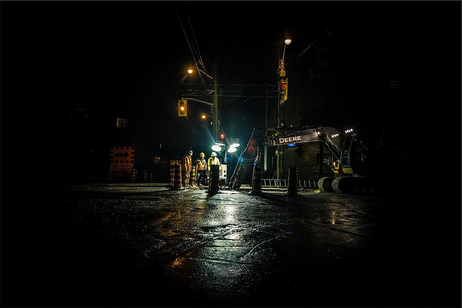 group, people road works, nighttime, close, three, person, standing, construction, workers, hard hats