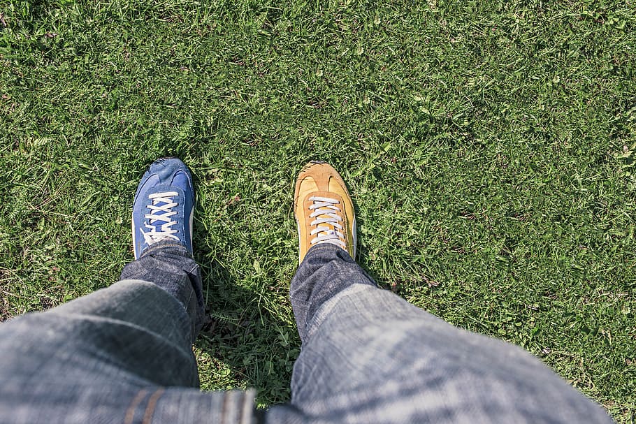 blue, brown, shoe, grass field, person, jeans, two, different, sneakers, standing