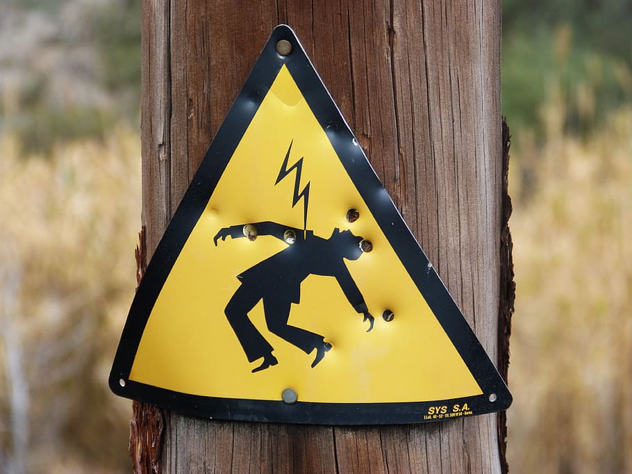 lightning hazard sign, wood post, danger, power line, electric shock, signal, yellow, communication, sign, representation