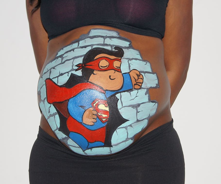 pregnant, woman, superman paint, tummy, standing, white, wall, bellypaint, belly, superman