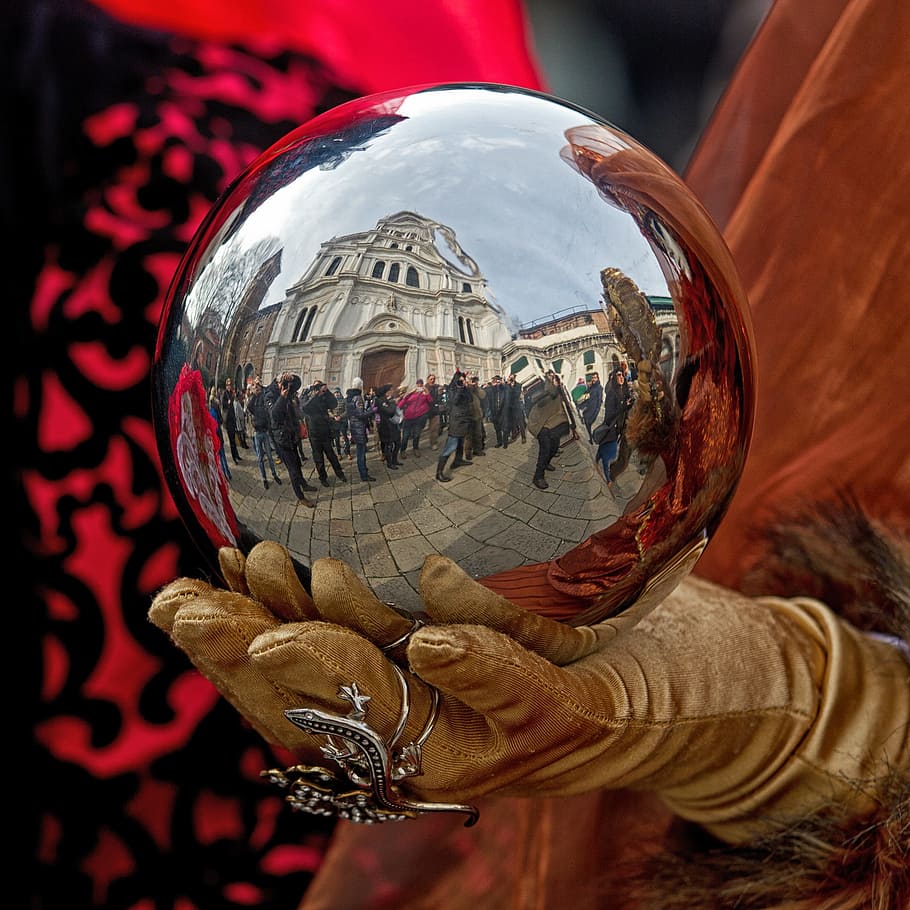 person, holding, stainless, steel egg, carnival, venice, mask, reflection, sphere, human hand