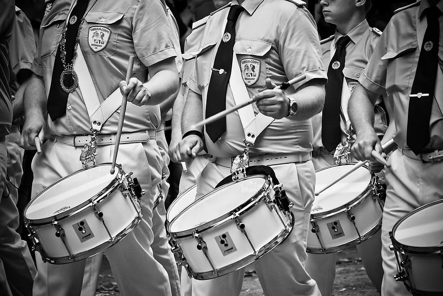 grayscale photo, men, marching, drums, drummer, drum, music, instrument, musician, musical instrument