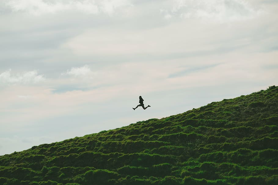 silhouette, person, mid, air, grass field, cloudy, sky, daytime, jumping, side