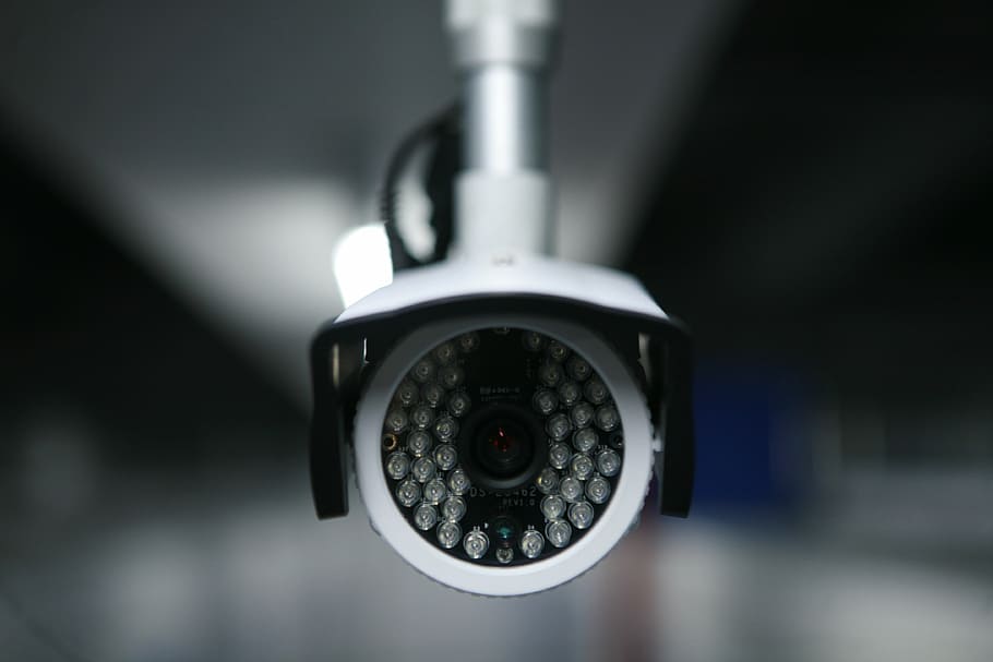 white cctv camera, mini storage, music stored music library mini warehouse, self-small warehouse, close-up, technology, indoors, focus on foreground, metal, circle