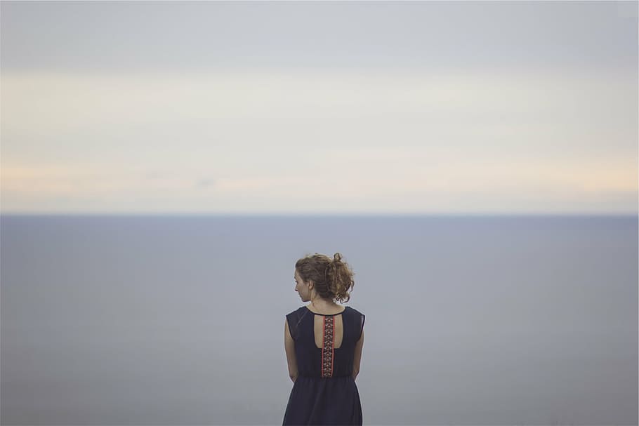 woman, looking, side, black, sleeveless, dress, standing, near, body, water