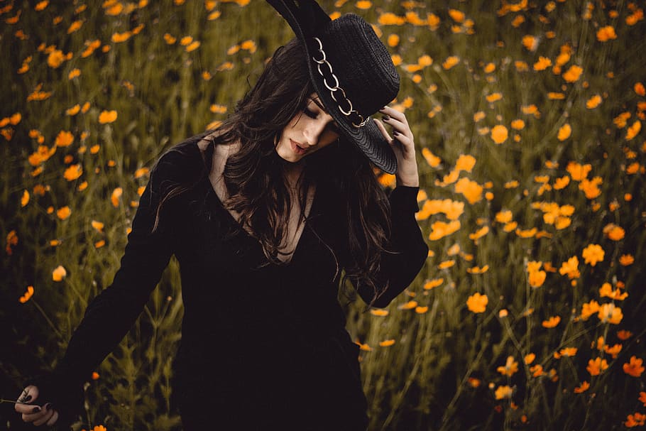 woman, black, scoop-neck, long-sleeved, dress, standing, petaled flower fields, girl, guy, hat