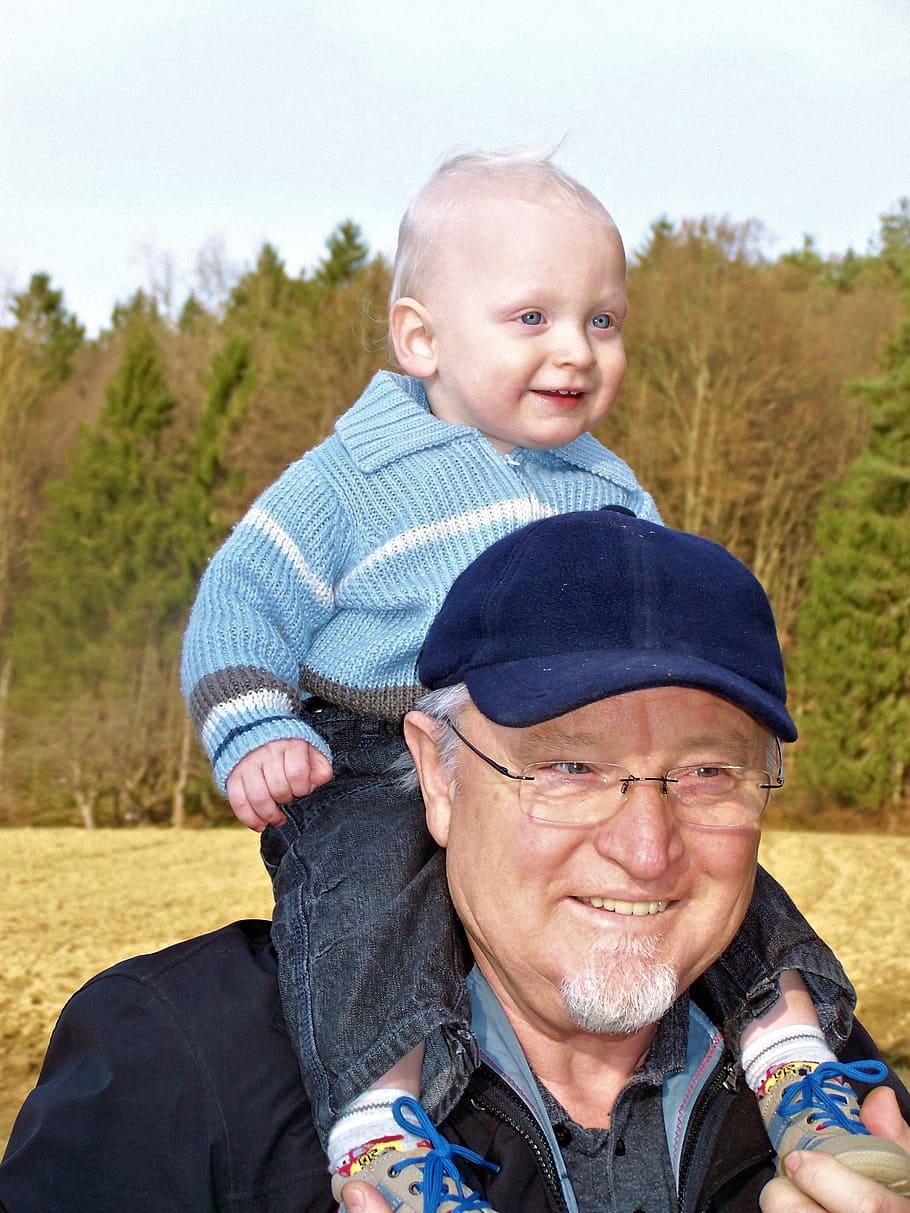 man carrying baby, grandpa, small child, bear, walk, spring, forest, arable, portrait, looking at camera