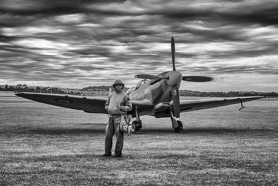 grayscale photography, man, standing, behind, plane, aircraft, spitfire, fighter, ww2, vintage