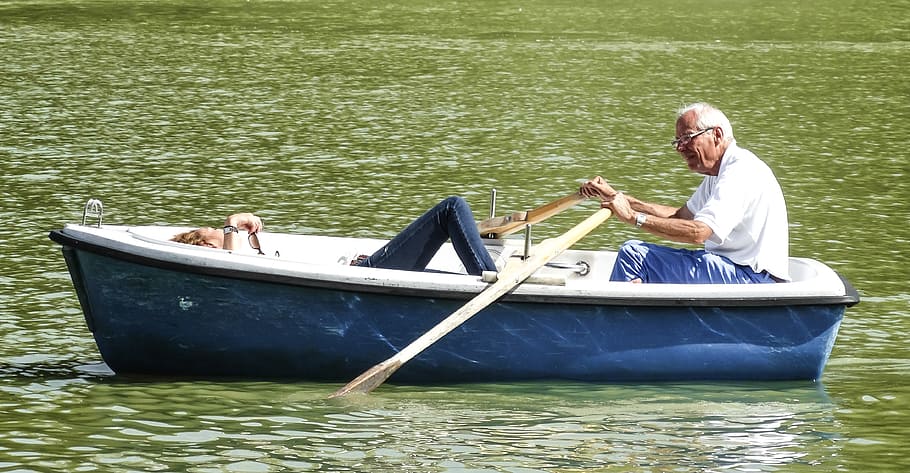 man, white, polo shirt, blue, boat, holding, paddle, daytime, man in white, in blue