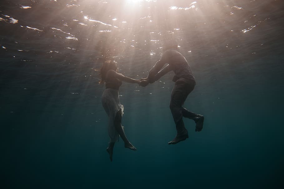 people, man, woman, holding hands, swimming, underwater, sea, ocean, water, lights